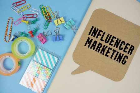 Influencer Marketing text with stationery on cover notebook background