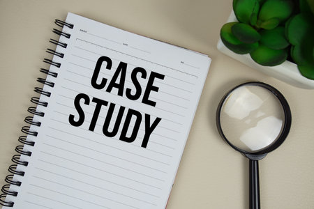 Case Study text on paper notebook with magnifying glass on beige leather backgroundの写真素材