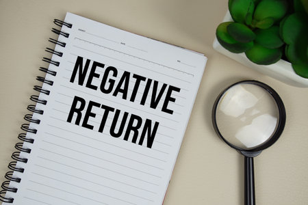 Negative Return text on paper notebook with magnifying glass on beige leather backgroundの写真素材