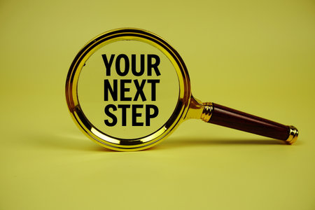 Your Next Step text with magnifying glass on yellow backgroundの写真素材