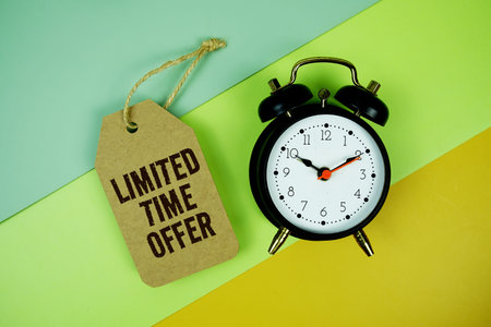 Limtited Time Offer text on price tag with alarm clock on yellow background