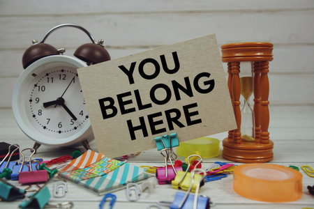 You Belong Here text on paper card with stationary on wooden backgroundの写真素材