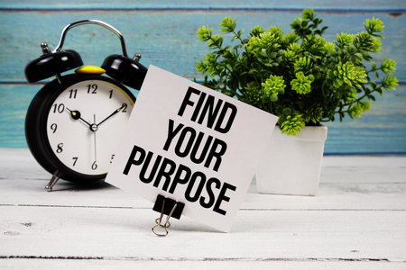 Find Your Purpose text written on paper card with alarm clock on wooden backgroundの写真素材