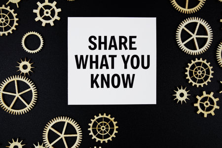 Share What You Know text on paper and gear on black backgroundの写真素材