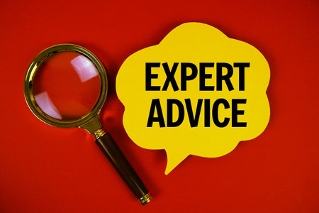 Expert Advice text with speech bubble and magnifying glass on red backgroundの写真素材