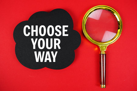 Choose Your Way text with speech bubble and magnifying glass on red backgroundの写真素材