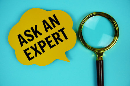 Ask an Expert text with speech bubble and magnifying glass on blue backgroundの写真素材