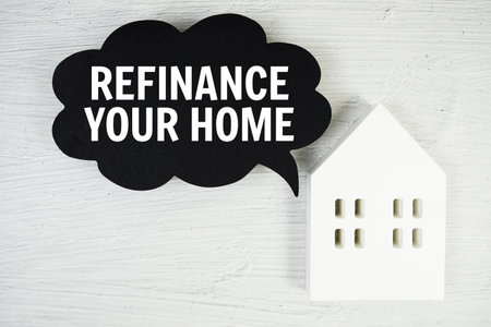 Refinance Your Home text message on speech bubble with house model on concrete backgroundの写真素材