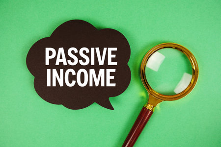 Passive Income text with speech bubble and magnifying glass on green backgroundの写真素材