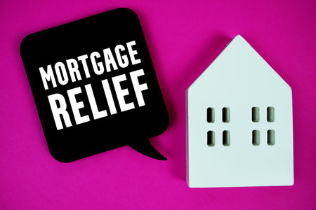 Mortgage Relief text with house model on pink backgroundの写真素材