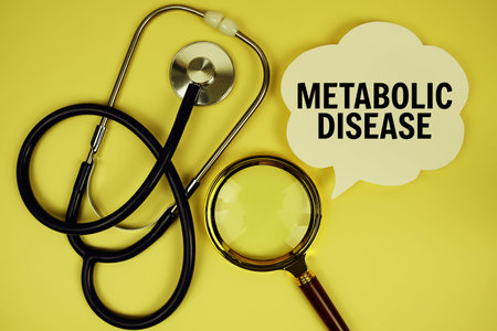 Metabolic Disease text message on paper card with stethoscope magnifying glass on yellow background