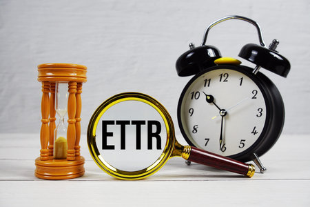 ETTR abbreviation of Estimated Time To Resolve text with alarm clock on wooden background