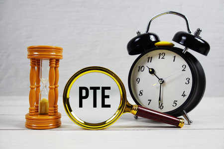 PTE abbreviation of Part time Equivalent text with alarm clock on wooden backgroundの写真素材