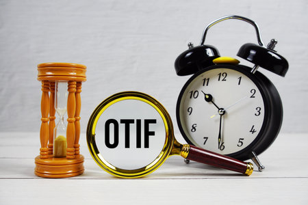 OTIF abbreviation of On Time In Full text with alarm clock on wooden backgroundの写真素材