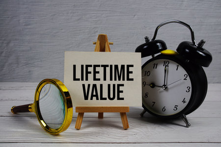 Lifetime Value text with alarm clcok and magnifying glass on wooden backgroundの写真素材