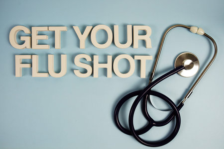 Get Your Flu Shot alphabet letters with stethoscope top view on blue background