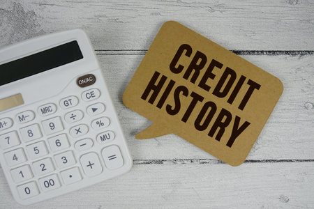 Credit History text with calculator on wooden backgroundの写真素材