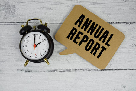 Annual Report text with alarm clock on wooden backgroundの写真素材