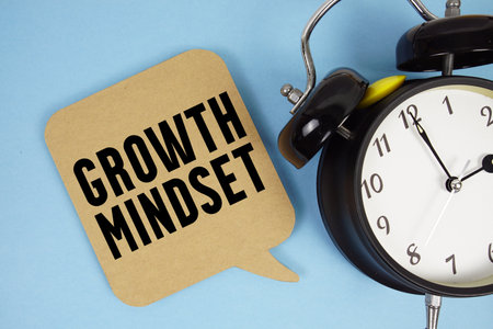 Growth Mindset text with alarm clock on blue backgroundの写真素材