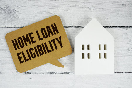 Home Loan Eligibility text with house models on wooden backgroundの写真素材