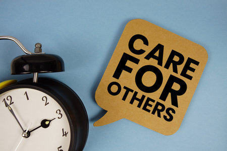 Care For Others text with alarm clock on blue background