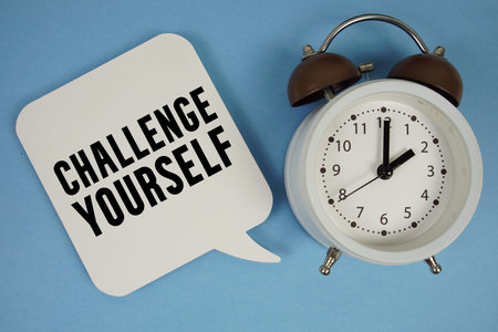 Challenge Yourself text with alarm clock on blue background