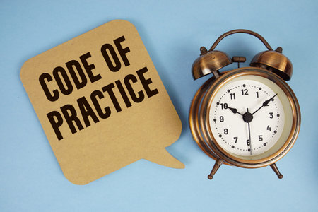 Code Of Practice text with alarm clock on blue backgroundの写真素材