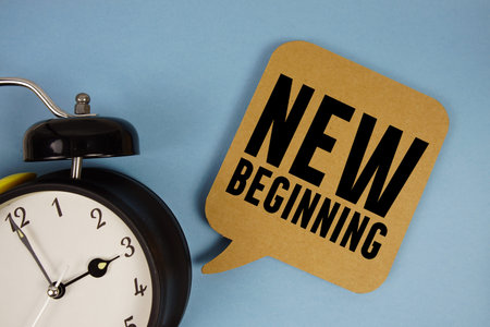 New Beginning text with alarm clock on blue background