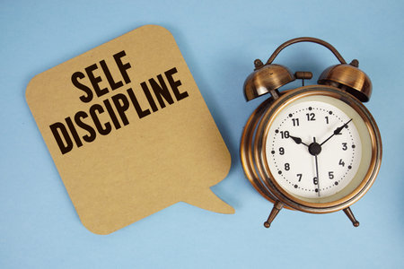 Self Discipline text with alarm clock on blue background