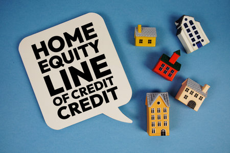 HELOC Home Equity Line of Credit text with house models on blue background
