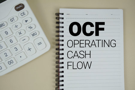 OCF Operating Cash Flow text with calculator phrase of business and financial concept