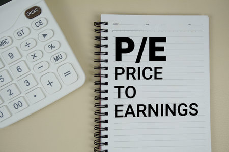P/E Abbreviations of Price-To-Earnings text with calculator phrase of business and financial concept