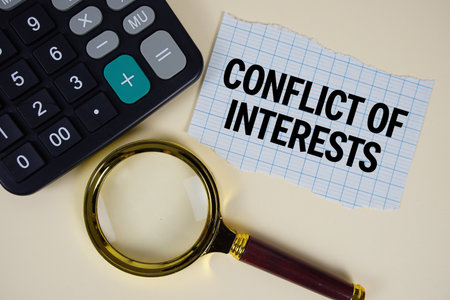 Conflict Of Interest text with magnifying glass anc calculator on yellow backgroundの写真素材