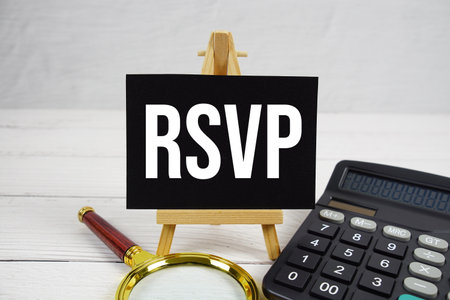 RSVP Respond, if you please text with magnifying glass and calculator on wooden backgroundの写真素材
