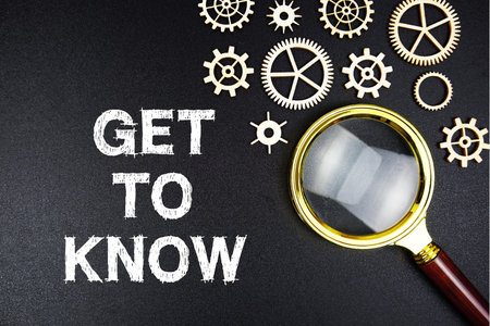 Get to Know text message with magnifying glass on black background
