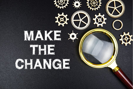 Make The Change text message with magnifying glass on black background