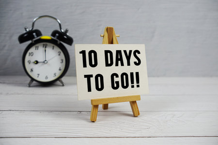 10 Days To Go! text with easel and alarm clock on wooden backgroundの写真素材