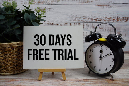 30 Days Free Trial text with alarm clock on wooden backgroundの写真素材