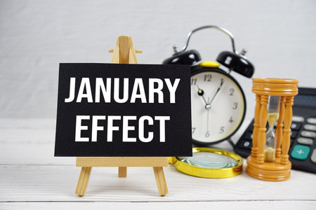 January Effect text with magnifying glass and calculator on wooden backgroundの写真素材