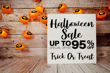 Halloween Sale 95% off text with LED pumpkin decoration on wooden backgroundの写真素材
