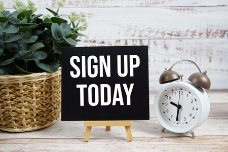 Sign up Today text with alarm clock on wooden backgroundの写真素材