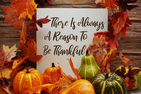 There Is Always A Reason To Be Thankful text with maple leaf decoration on wooden backgroundの写真素材