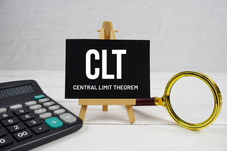 CLT abbreviation of Central Limit Theorem text with magnifying glass and calculator on wooden backgroundの写真素材