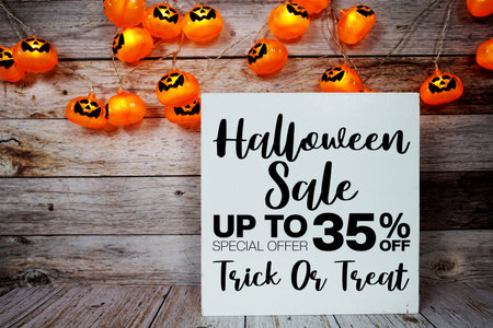 Halloween Sale 35% off text with LED pumpkin decoration on wooden backgroundの写真素材