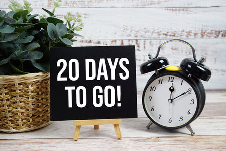 20 Days To Go! text with alarm clock on wooden backgroundの写真素材