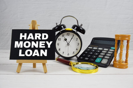Hard Money Loan text with magnifying glass and calculator on wooden backgroundの写真素材