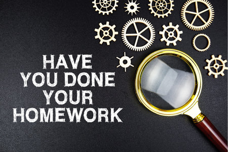 Have You Done Your Homework? text message with magnifying glass on black backgroundの写真素材