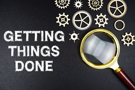 Getting Things Done text message with magnifying glass on black backgroundの写真素材