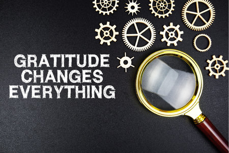 Gratitude Changes Everything text message with magnifying glass on black backgroundの写真素材