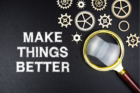 Make Things Better text message with magnifying glass on black backgroundの写真素材
